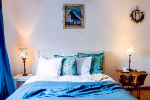 Wnętrze sypialni z niebieskimi dodatkami.